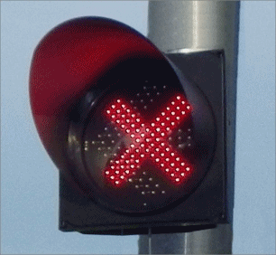 300mm Red X LED traffic signal head mounted on pole showing illuminated red X indicator"
